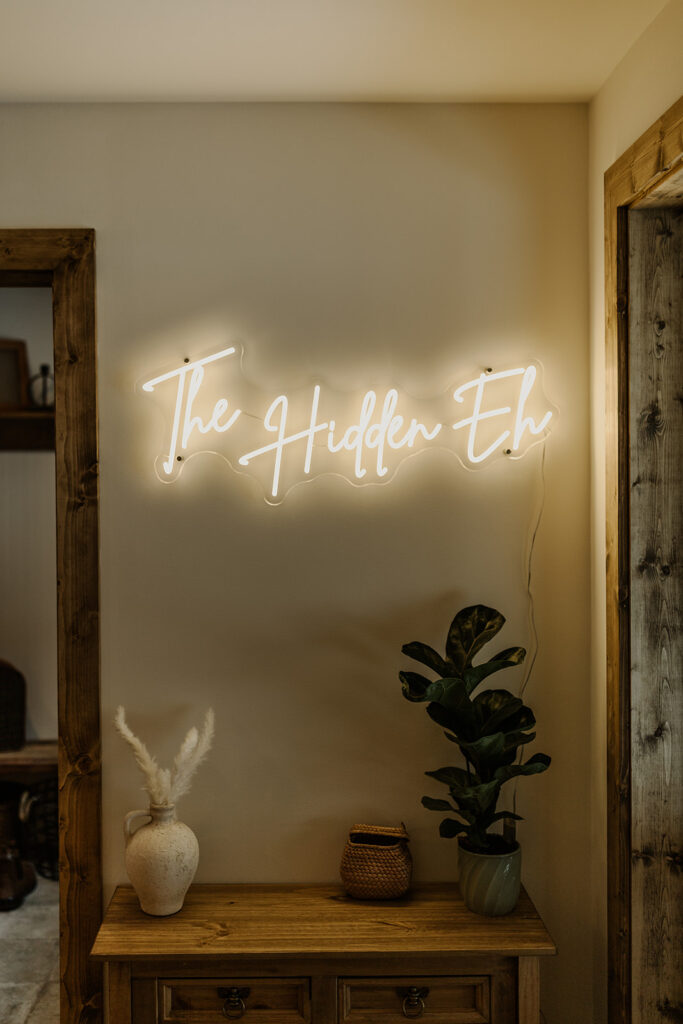 The Hidden Eh neon sign cabin rental sunshine valley